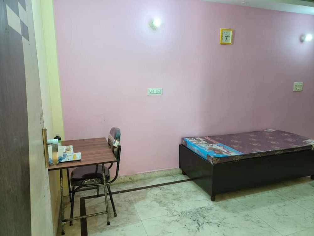 Private single room PG in Sector 13 Dwarka with bed, study table and chair