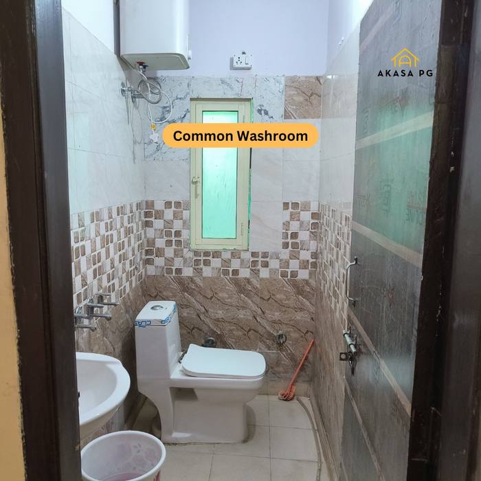 Clean common washroom with geyser at Akasa PG Sector 13 Dwarka